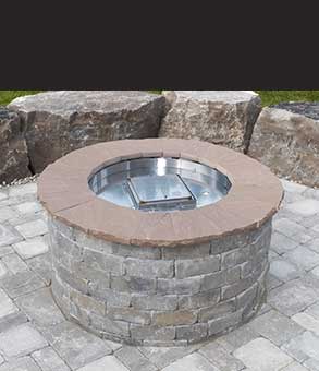 We install natural stone backyard fire pits like this one